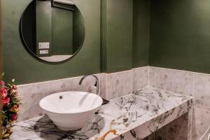 a bathroom with a sink and a mirror at Magic House Hostel in Hua Hin +99 photos