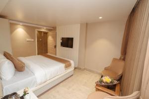 a hotel room with a bed and a chair at PENANG Home Away From Home in Darjeeling