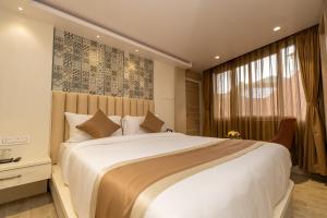 a bedroom with a large white bed and a window at PENANG Home Away From Home in Darjeeling