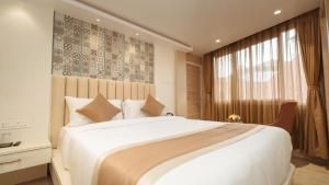 a bedroom with a large white bed and a window at PENANG Home Away From Home in Darjeeling