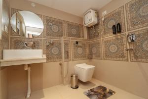 a bathroom with a toilet and a sink and a mirror at PENANG Home Away From Home in Darjeeling