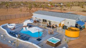 an aerial view of a swimming pool at a resort at Pool Spa Pickleball Piano Near Pioneertown Harmony House by AvantStay in Yucca Valley