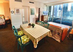 a room with a table and chairs and a bed at Melborne Collins Home in Melbourne
