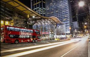 a red double decker bus parked at a bus stop at Melborne Collins Home in Melbourne