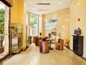a lobby of a store with tables and chairs at GreenTree Inn Jieyang North Linjiang Road Express Hotel in Jieyang