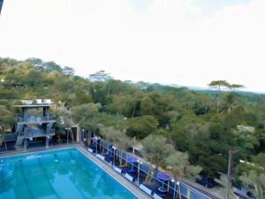 arial view of a swimming pool on a resort at Capital O 887 Green Hill Hotel And Convention Center in Jember