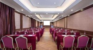 a conference room with purple tables and chairs at Vienna Classic Hotel Qingyuan Taihe Ancient Cave Scenic Area in Qingyuan