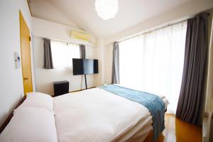Giường trong phòng chung tại goom Hotel Nakasu Maxim +24 ảnh