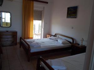 a bedroom with two beds and a window at The Village in Igoumenitsa