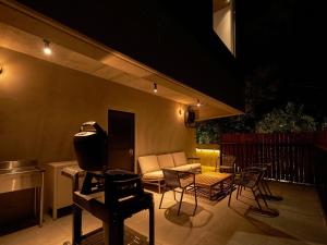 a patio with a couch and chairs and a table at N3 ATAMI"Forest" - Vacation STAY 30932v in Atami