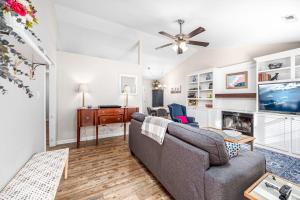 a living room with a couch and a tv at Cozy Pet-friendly home in Five Points Raleigh in Oberlin