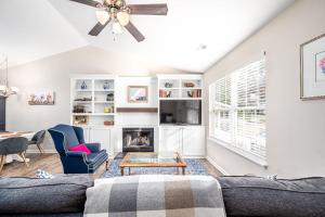 a living room with a couch and a fireplace at Cozy Pet-friendly home in Five Points Raleigh in Oberlin