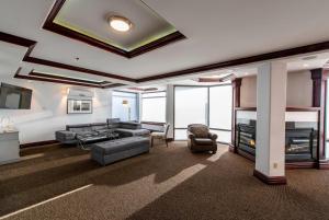 a living room with a couch and a fireplace at Georgian Bay Hotel Trademark Collection by Wyndham in Collingwood