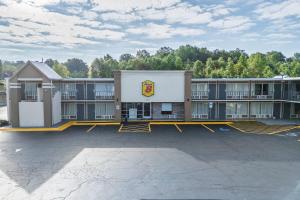 an empty parking lot in front of a hotel at Super 8 by Wyndham Morganton in Morganton