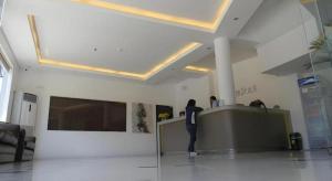 a person standing at a counter in a room at Fiesole Residence Inn in Dumaguete