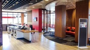 a lobby of an office with a counter and chairs at ibis Jatai in Jataí