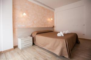 a bedroom with a bed with two towels on it at Carillon in Civitavecchia