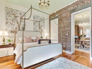a bedroom with a bed and a brick wall at Gordon Inn Live Oak in Savannah +46 photos