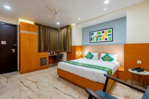 a hotel room with a bed and a desk at Treebo Premium Ocean Echo, Rushikonda in Rushikonda +47 photos