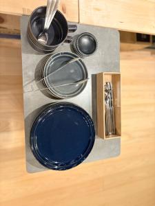 a counter with a blue plate and pans on it at Tsubame in Zushi