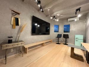 a room with a bench and a table and two chairs at Tsubame Zushi Hayama in Zushi