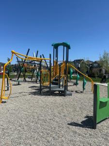 a playground with a bunch of playground equipment at Sunny Queen-size Bedroom with Private Bath in Brand New House in Calgary