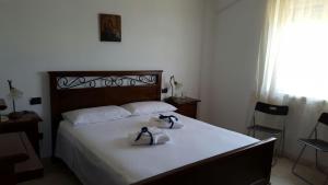 a bedroom with a bed with two shoes on it at Scala Dei Turchi in Realmonte