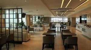 a lobby with couches and tables in a building at Nuohuating Hotel in Zhaoqing