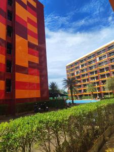 a hotel and a resort with a pool and palm trees at Уютная студия в жилом комплексе в заповедном уголке Пхукета in Ban Mai Salae +8 photos
