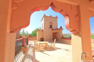 
a patio area with a table and chairs at La Perle Du Dades in Boumalne Dades
