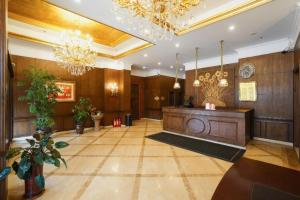 a large lobby with a podium in a building at Anshan Camilla Business Hotel in Anshan