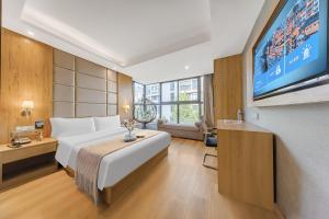Ένα ή περισσότερα κρεβάτια σε δωμάτιο στο Zhuo Ao Hotel