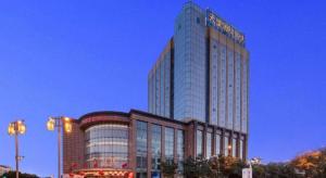 a tall building with a sign on the side of it at Datong Tiangui International Hotel in Datong