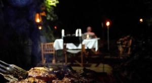 a person sitting at a table in front of a table with a tableablishbestos at Explorer by Eco Team - Dambana in Mahiyangana +61 photos