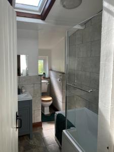 a bathroom with a tub and a toilet and a sink at Character Cottage in Usk in Usk