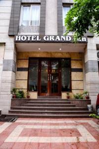 a hotel grand entrance with stairs in front of a building at Hotel Grand Inn Near Vaishali Metro Station in New Delhi
