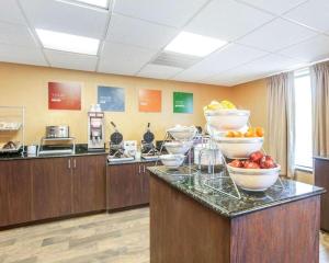 a kitchen with bowls of fruit on a counter at Comfort Suites in Rome