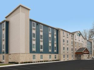 an exterior view of a building at WoodSpring Suites Orlando East UCF in Orlando