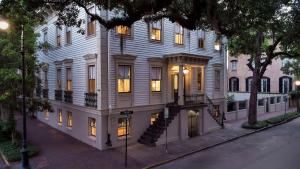 a large white building with a staircase in front of it at 3 W Perry St in Savannah
