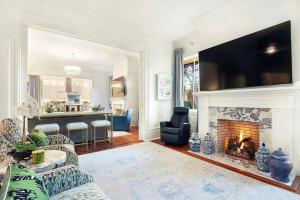 a living room with a fireplace with a tv above it at 3 W Perry St in Savannah
