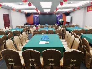 a conference room with green tables and chairs at Shenzhen Kai Long International Hotel in Shenzhen