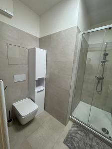 a bathroom with a toilet and a glass shower at Apartman Nitra in Nitra +5 photos