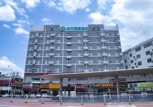 a large gray building with a sign on top of it at City Comfort Inn Nanning Normal University Changgang Road Metro Station in Nanning