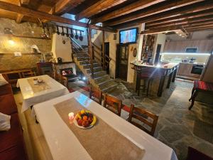 a room with a table with a bowl of fruit on it at Костовският хан in Chepelare