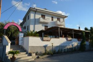 a white building with stairs in front of it at B&B Collemare in Drapia