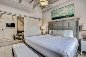 a bedroom with a large bed and a tv at Parker's Collection Unit 8 in Savannah +31 photos