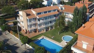 an aerial view of a house with a swimming pool at Apartamentos Sunway San Jorge in Sitges