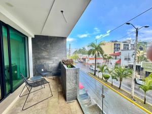 a balcony with chairs and a view of a street at Luxury Apartment top location! in Playa del Carmen +14 photos