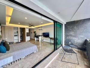 a bedroom with a bed and a glass wall at Luxury Apartment top location! in Playa del Carmen