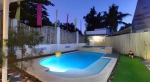 a small swimming pool with a ball in a yard at House of Big Brother in Puerto Princesa City